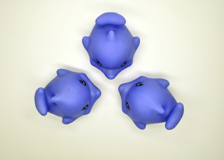 One big purple Dolphin and three small purple Dolphin for kids to play in the bathtub on a white background all togetherの写真素材