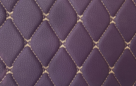 classic purple leather Mat with straight beige stitching soft leather for machine with textured pattern concept background fabric businessの写真素材