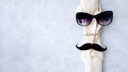 Daddy's day concept, magnets hat, glasses, mustache, and bow tie on fabric background for bags. Concep ecoの写真素材