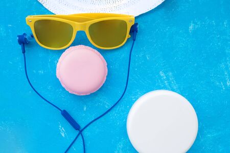 woman holding sunglasses on bright background, cosmetic summer vacation concept with pink noseの写真素材