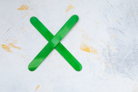 multiplication sign is made of wooden sticks. A simple rainbow made from wooden ice creamの写真素材