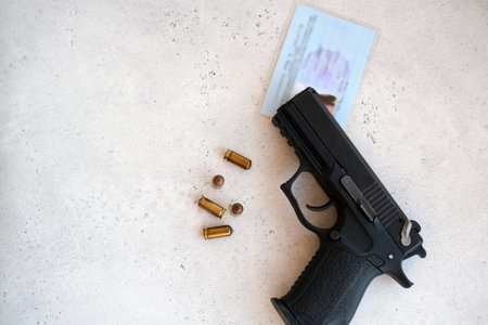 A handgun with bullets symbolizing gun rights while framed against the United States constitution.