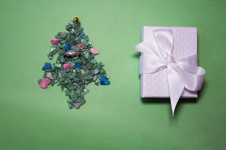 celebration, winter holidays and advertisement concept - christmas tree with gifts and santa hat...