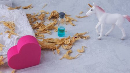 heart stimulating drink, unicorn white lingerie and flower petals.の写真素材