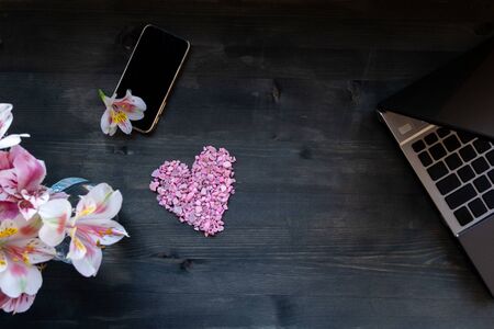 concept remote work laptop and phone, flowers and heart, free space for inscriptions, mockupの写真素材