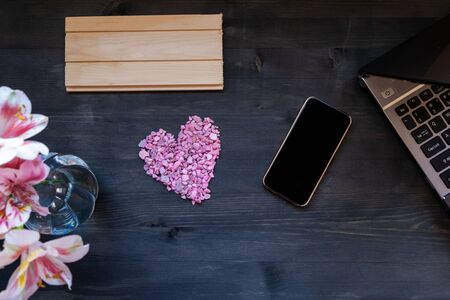 concept remote work laptop and phone, flowers and heart, free space for inscriptions, mockupの写真素材