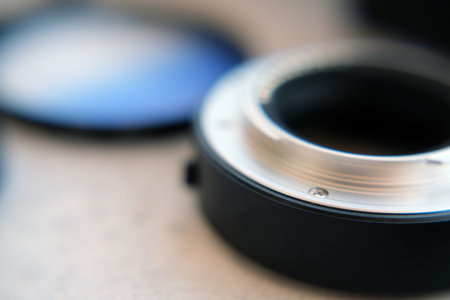 Closeup macro photo of part of a reflective metallic lens extension tube. composition with equipment...