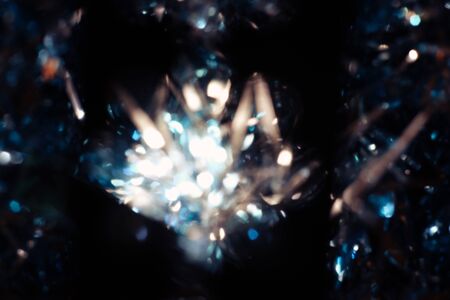Dark abstract blue bokeh sparkle on black background. Lights of the color background. Defocus different colors lights. Abstract bright blured colored bokeh.の写真素材