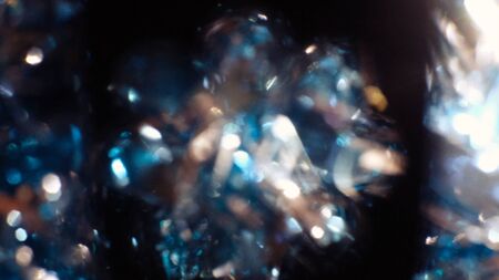 Dark abstract blue bokeh sparkle on black background. Lights of the color background. Defocus different colors lights. Abstract bright blured colored bokeh.の写真素材