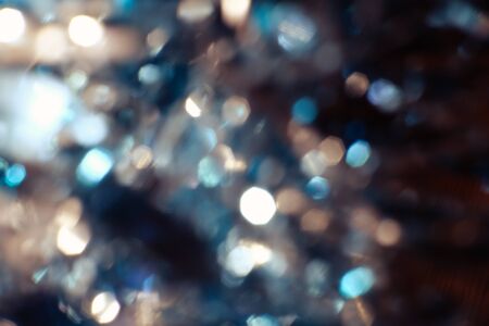 Dark abstract blue bokeh sparkle on black background. Lights of the color background. Defocus different colors lights. Abstract bright blured colored bokeh.の写真素材