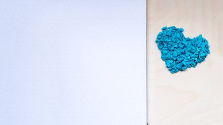 Valentine's day frame composition. Blue hearts blank sheet of paper on white background. Top view, flat lay, copy space. Template design invitation card, mock up, from above..の写真素材