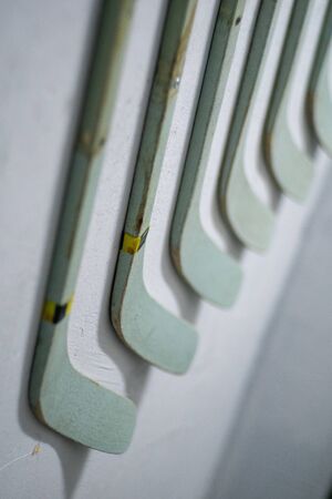 old wooden hockey sticks wood with grip isolated on grey background. This has clipping path.の写真素材