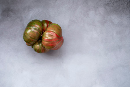 Ugly organic colorful tomatoes on grey. Concept organic vegetablesの写真素材