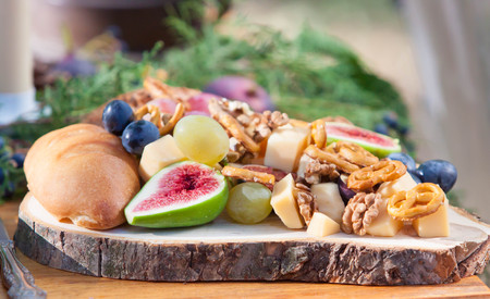 wood plate whith figs nuts and cheaseの写真素材