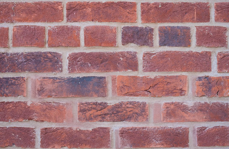 Old wall of red bricks tiled background, regular block texture. Wallpaper of ordinary building. Tiles. Backgroundの写真素材