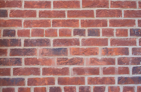Old wall of red briks tiled background, regular block texture. Wallpaper of ordinary building. Tiles. Backgroundの写真素材