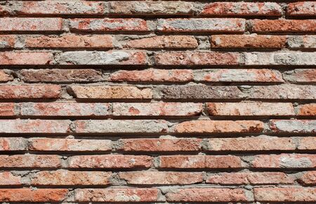 Old wall of red briks tiled background, regular block texture. Wallpaper of ordinary building. Tiles. Backgroundの写真素材