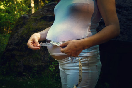 pregnancy woman and measuring tape