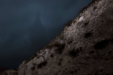 castle tower silhouette in fogの写真素材