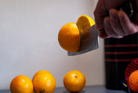 a man professionally cuts a orange