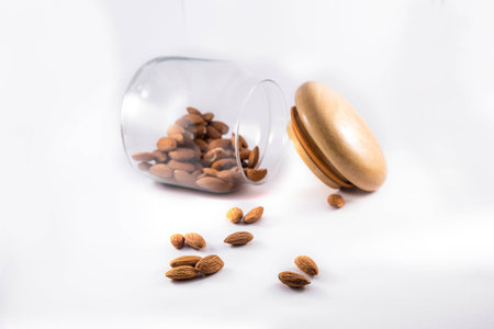 Nuts with glass flask on white backgroundの写真素材