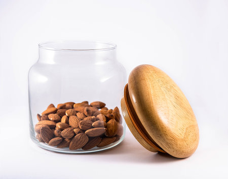 Nuts with glass flask on white backgroundの写真素材