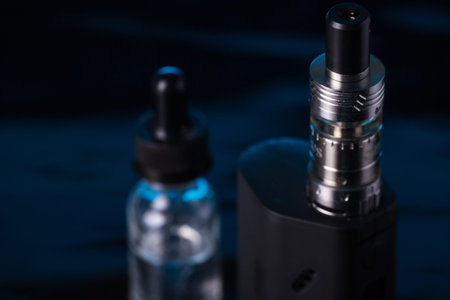 photos of electronic cigarette dark blue glossy background