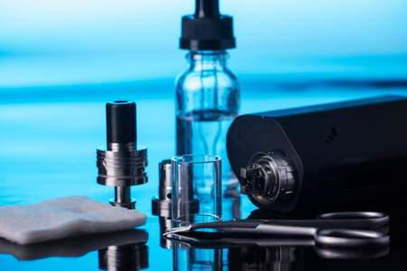 photos of electronic cigarette dark blue glossy backgroundの写真素材