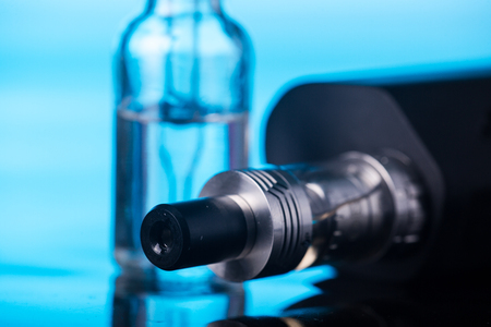 photos of electronic cigarette dark blue glossy backgroundの写真素材