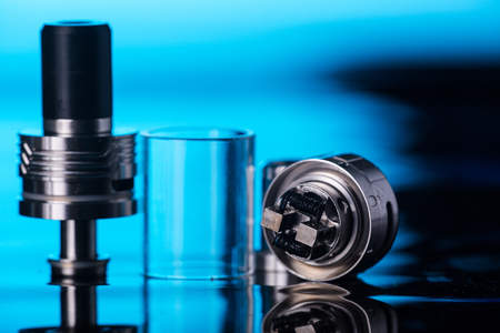 photos of electronic cigarette dark blue glossy backgroundの写真素材