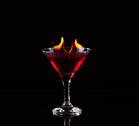Flaming cocktail over blackの写真素材