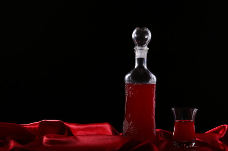 glass and bottle of wine on a dark background silkの写真素材