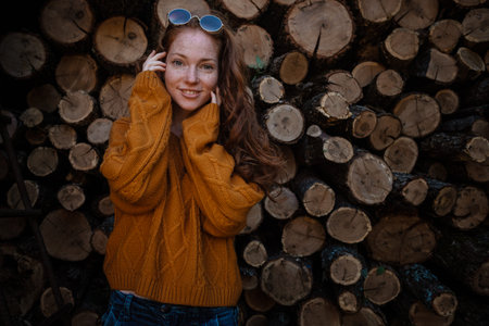 beautiful amazing gorgeous redhair girl spins in yellow sweater, jeans and glasses on the background...