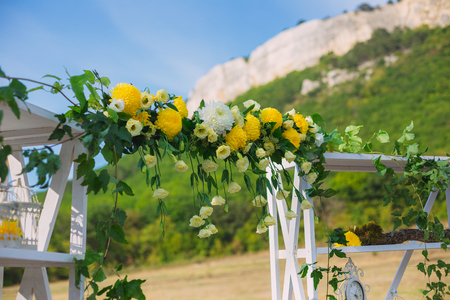 Wedding decor. Wedding on a plate green background and a mountains. Wedding decorations, pears and moss. Tints of green and yellowの写真素材