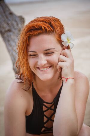 Young fashion woman relax on the beach. Happy island lifestyle. White sand, blue cloudy sky and crystal sea of tropical beach. Ocean beach relax, travel to Thailand, Krabi, hotel Grand Centaraの写真素材