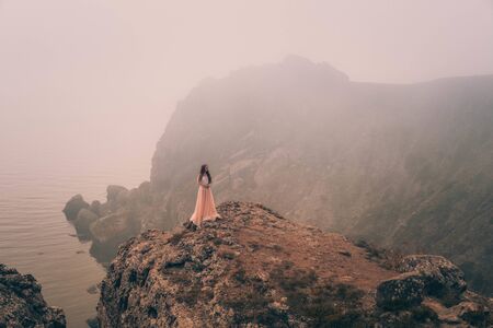beautiful young girl in the morning under the water. Mysterious Woman in White Dress, vintage filterの写真素材