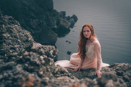 beautiful young girl in the morning under the water. Mysterious Woman in White Dress, vintage filterの写真素材