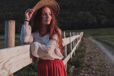 happy laughing girl holding straw walking in the green summer parkの写真素材