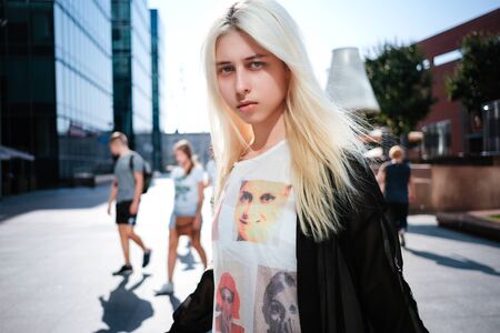 Beautiful young albino woman posing near a business center in Moscow. Japanese fashion, unusual styleの写真素材
