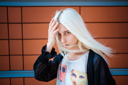 Beautiful young albino woman posing near a business center in Moscow. Japanese fashion, unusual...