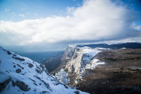 A frosty and sunny day is in mountains. Snow winter mountain lake bright and earlyの写真素材