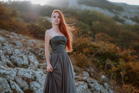 beautiful furious scandinavian warrior ginger woman in grey dress with metal chain mail. Woman is a Viking. Fantasy. Book Coverの写真素材