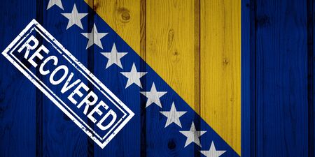 flag of Bosnia and Herzegovina that survived or recovered from the infections of corona virus epidemic or coronavirus. Grunge flag with stamp Recoveredの写真素材
