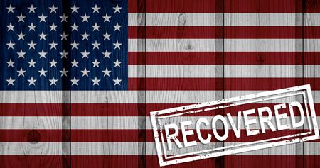 flag of United States that survived or recovered from the infections of corona virus epidemic or coronavirus. Grunge flag with stamp Recoveredの写真素材