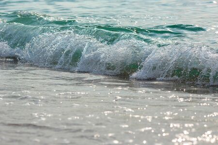 Sea tide splashes, turbulent water closeup. Surface of the sea waves, splash, foam and bubbles at high tide and surf, aqua abstract backgroundの写真素材