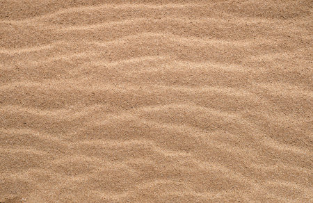 Golden texture of sand. Closeup sand on the beach using as background. Beautiful desert