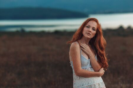 Positive natural close up portrait of young gorgeous caucasian ginger girl with freckles. Healthy lifestyle, beauty, natural concept. Melancholic beautiful portraitの写真素材