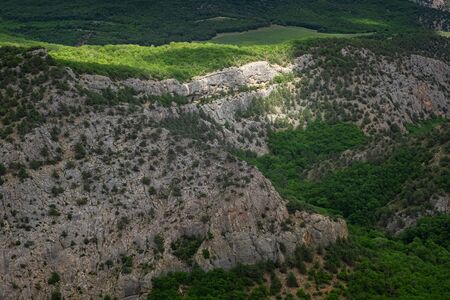 Mountains covered by a young green forest in cloudy weather in spring. Before the storm. Crimean mountains, Chernorechensky canyonの写真素材