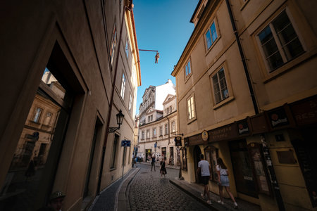 Prague, Czechia - 10.08.2019. The architecture of the old city of Prague. Ancient buildings, cozy streets. Man hanging out. an artwork by David Cerny in old town, depicting Sigmund Freud.のeditorial素材