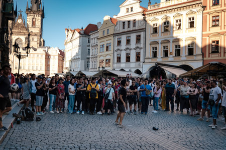 Prague, Czechia - 10.08.2019. The architecture of the old city of Prague. Ancient buildings, cozy streets. guy shows football tricks on the street of the old town of Pragueのeditorial素材